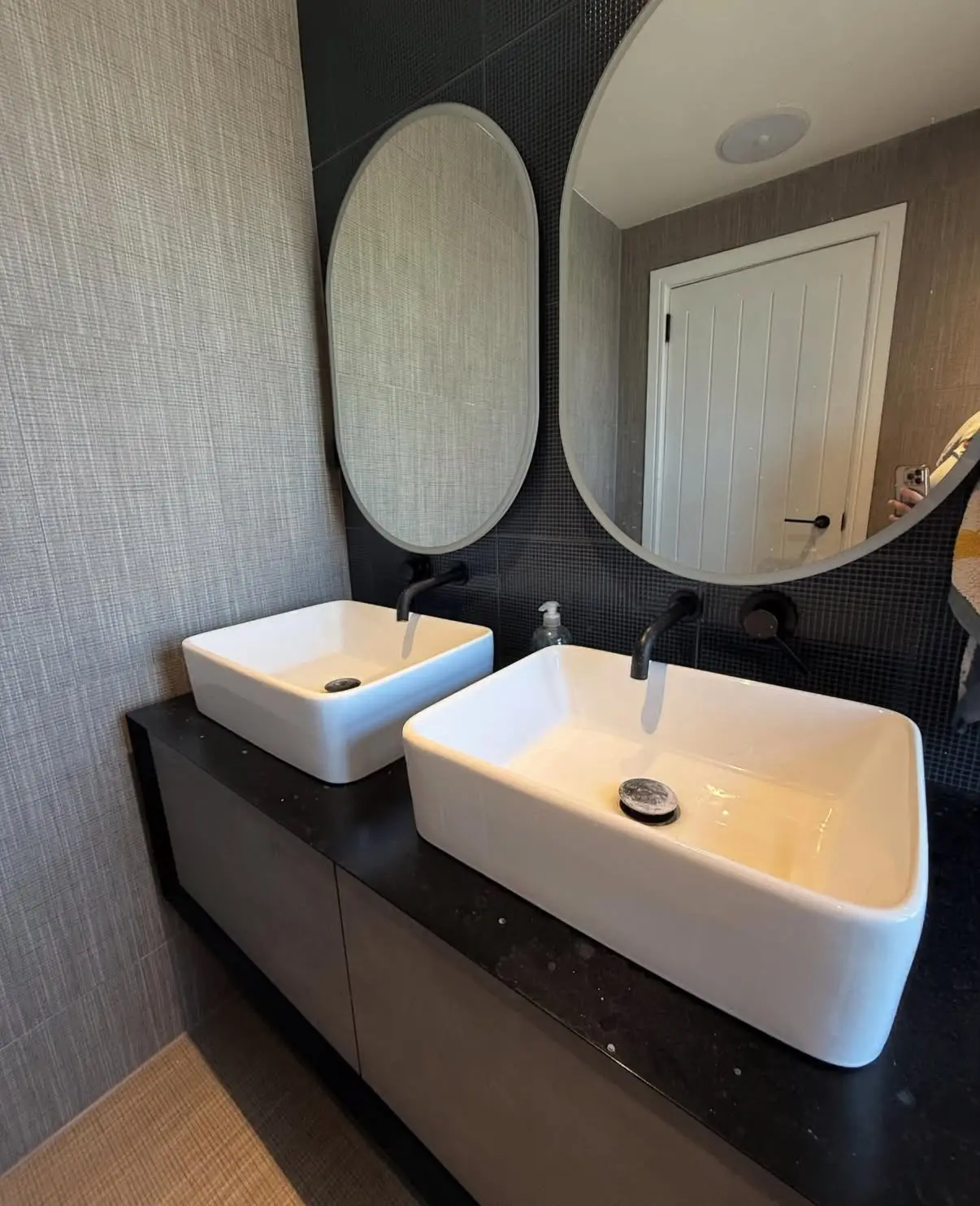 Dark bathroom vanity before cleaning